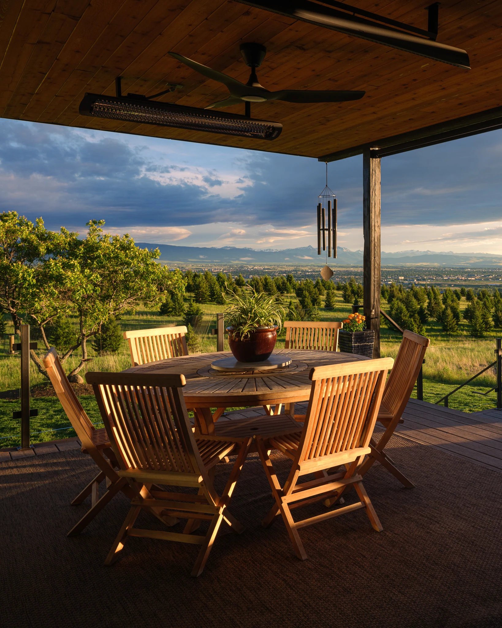 Covered patio dining table at golden hour above the valley — architectural photography Bozeman Montana, Bozeman Overlook